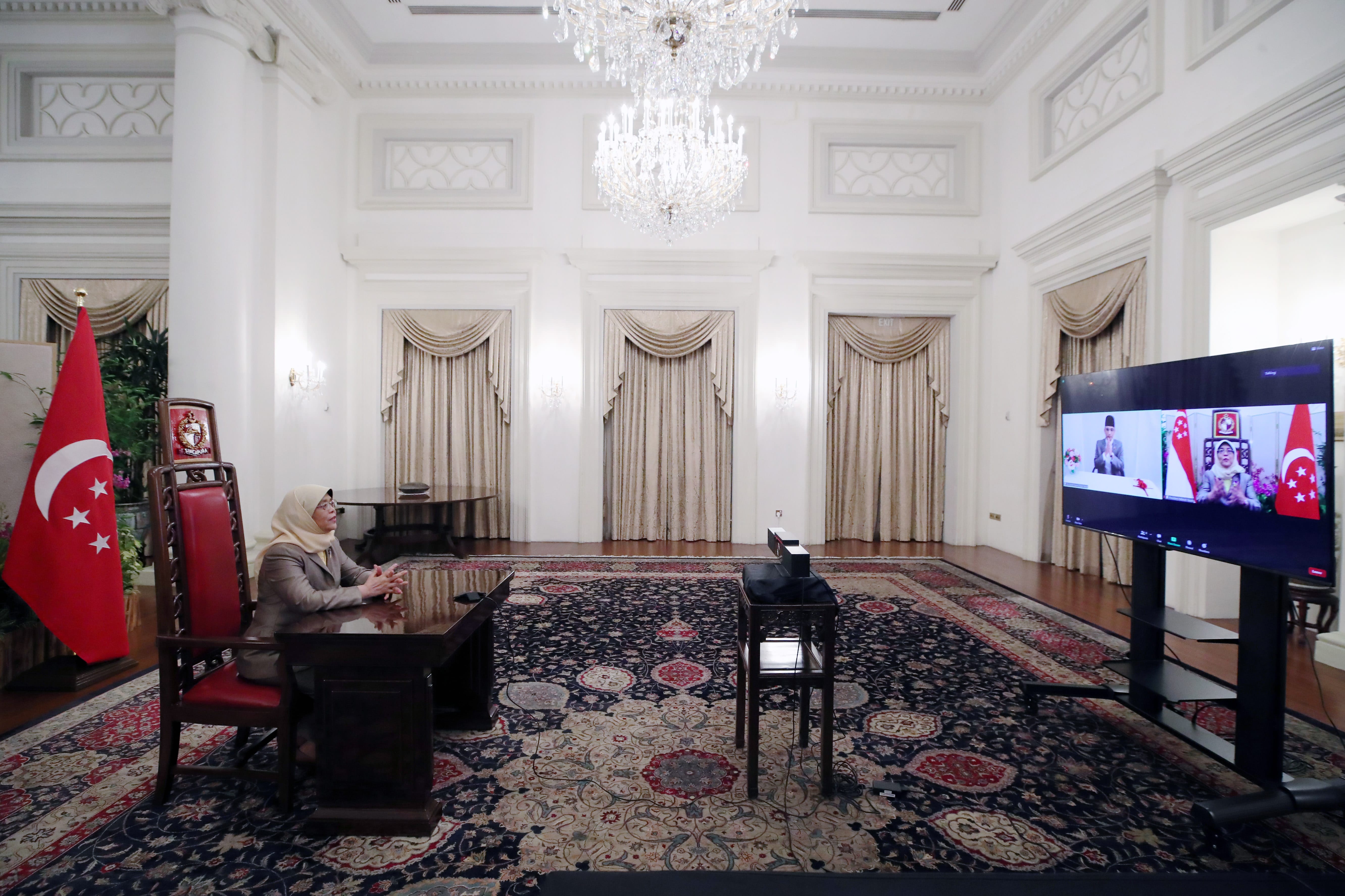 Halimah Yacob on video call, Singapore flag, ornate room.